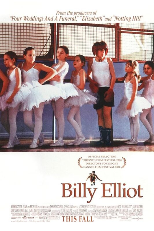 Boy in boxing gloves among ballerinas.