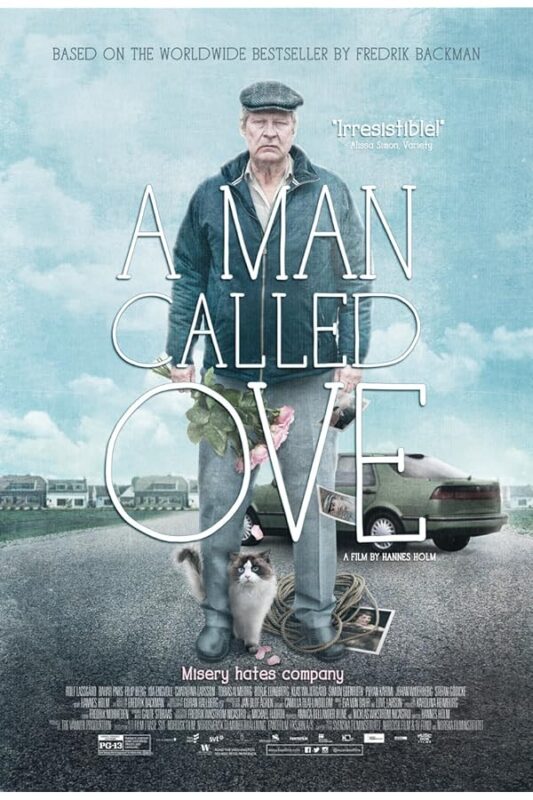 Older man holding roses, cat at feet