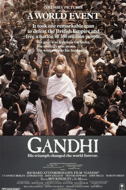 Elderly bald man among cheering crowd