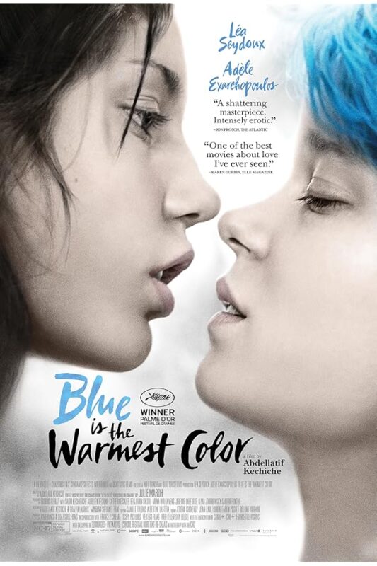 Two women face-to-face, one with blue hair