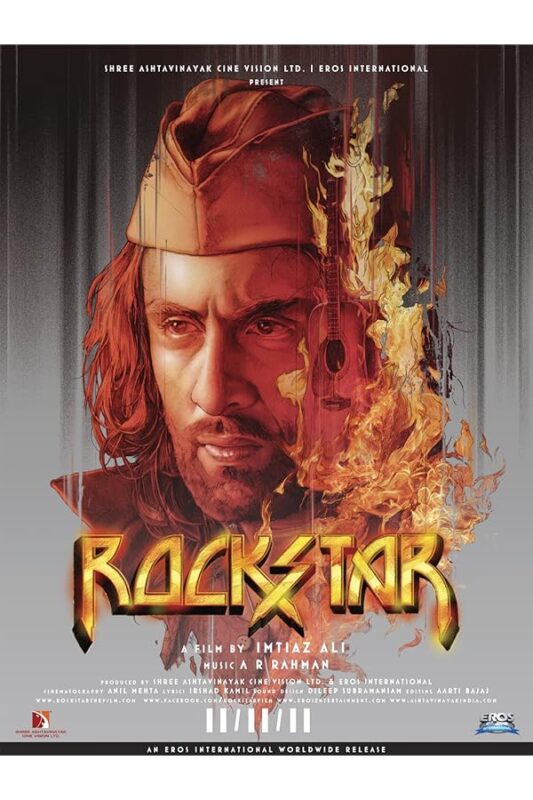 Portrait of long-haired man with burning guitar