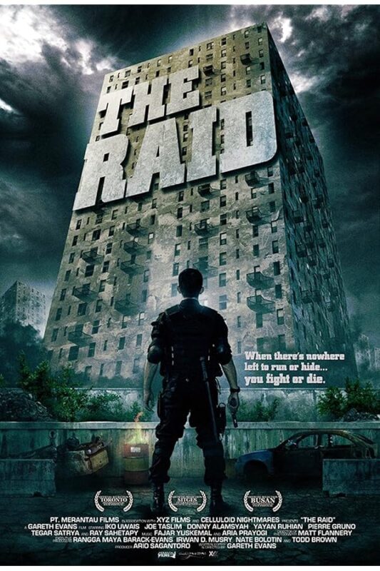 Armed man faces towering apartment building