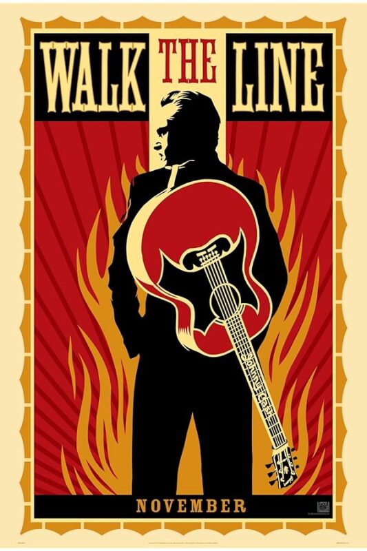 Silhouetted man holding guitar amid flames.