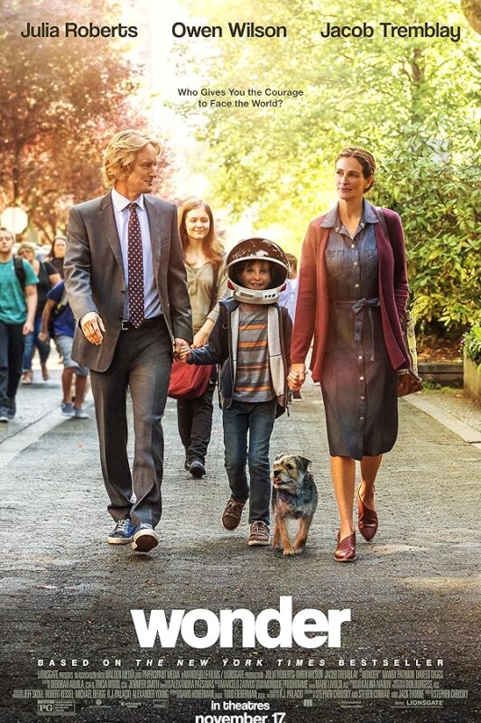 Parents walking with child in astronaut helmet
